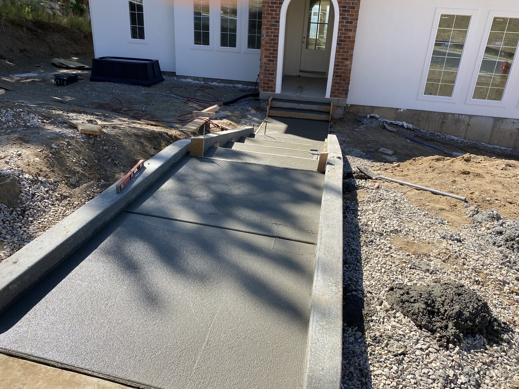 Real Bristow Concrete front walkway project beside a Northern Utah home